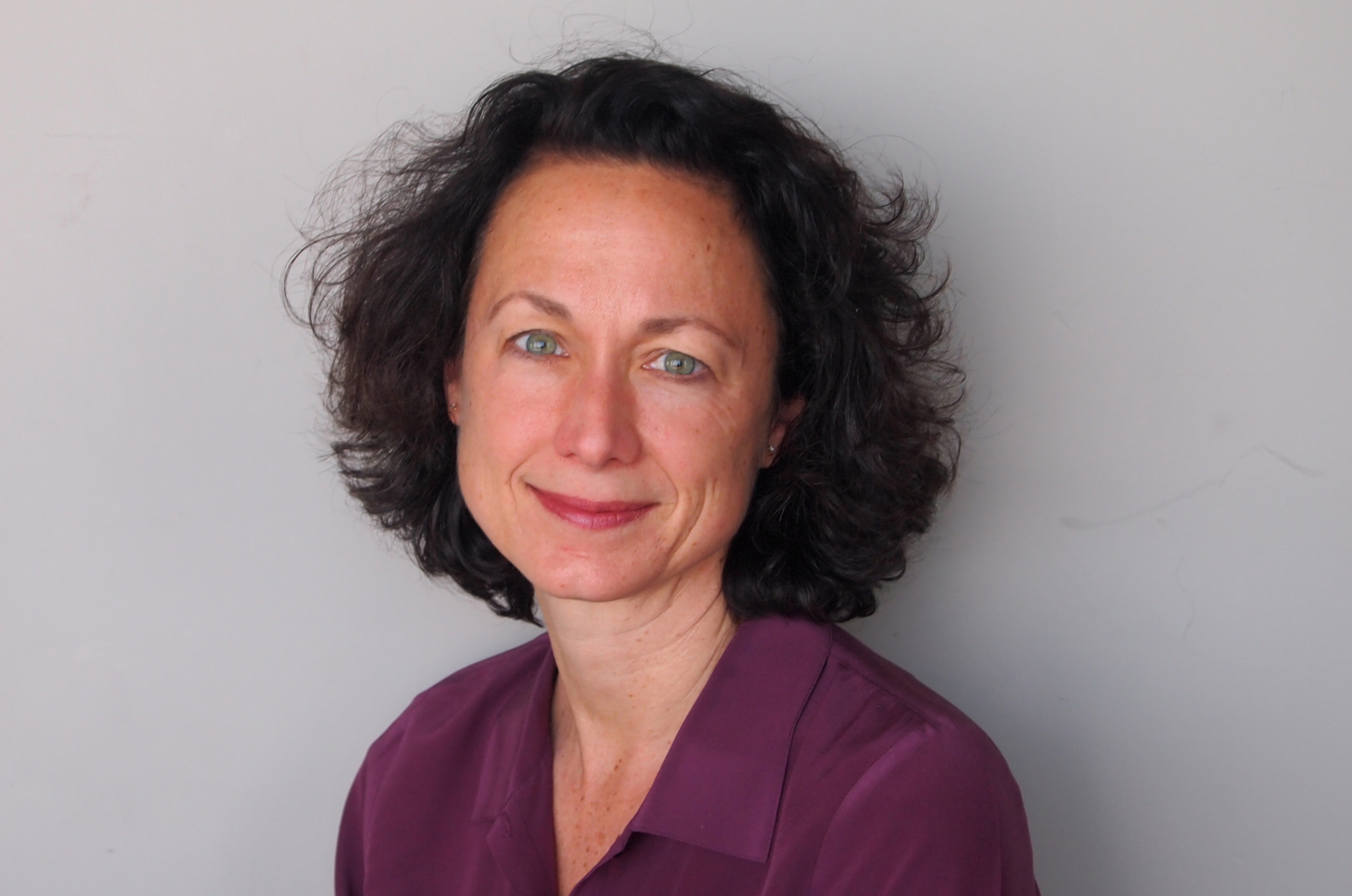 Woman in purple shirt smiles