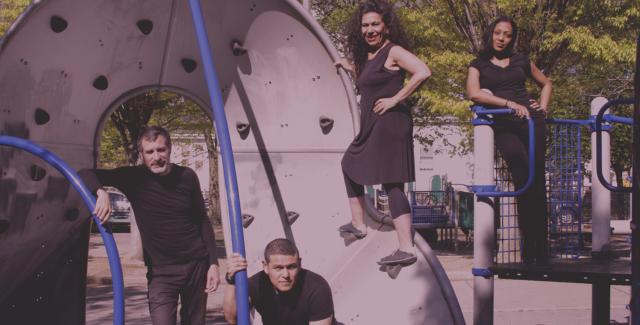 Two women and two men pose in a playground.