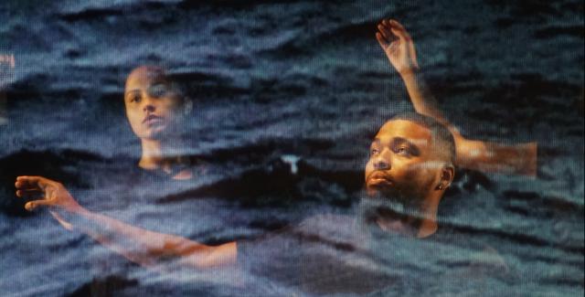 Three people with arms outstretched with arms outstretched as if swimming