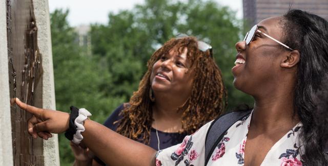L'Merchie and two students look at a monument in Boston Common.