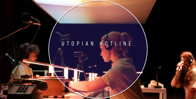 At desks, three folks wear headsets and are mic'ed. Over the image: a circular frame with "Utopian Hotline" in the center.