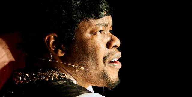 Close up of Jaamil's face on stage.