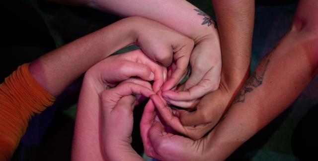 Hands intersect into a spinwheel.