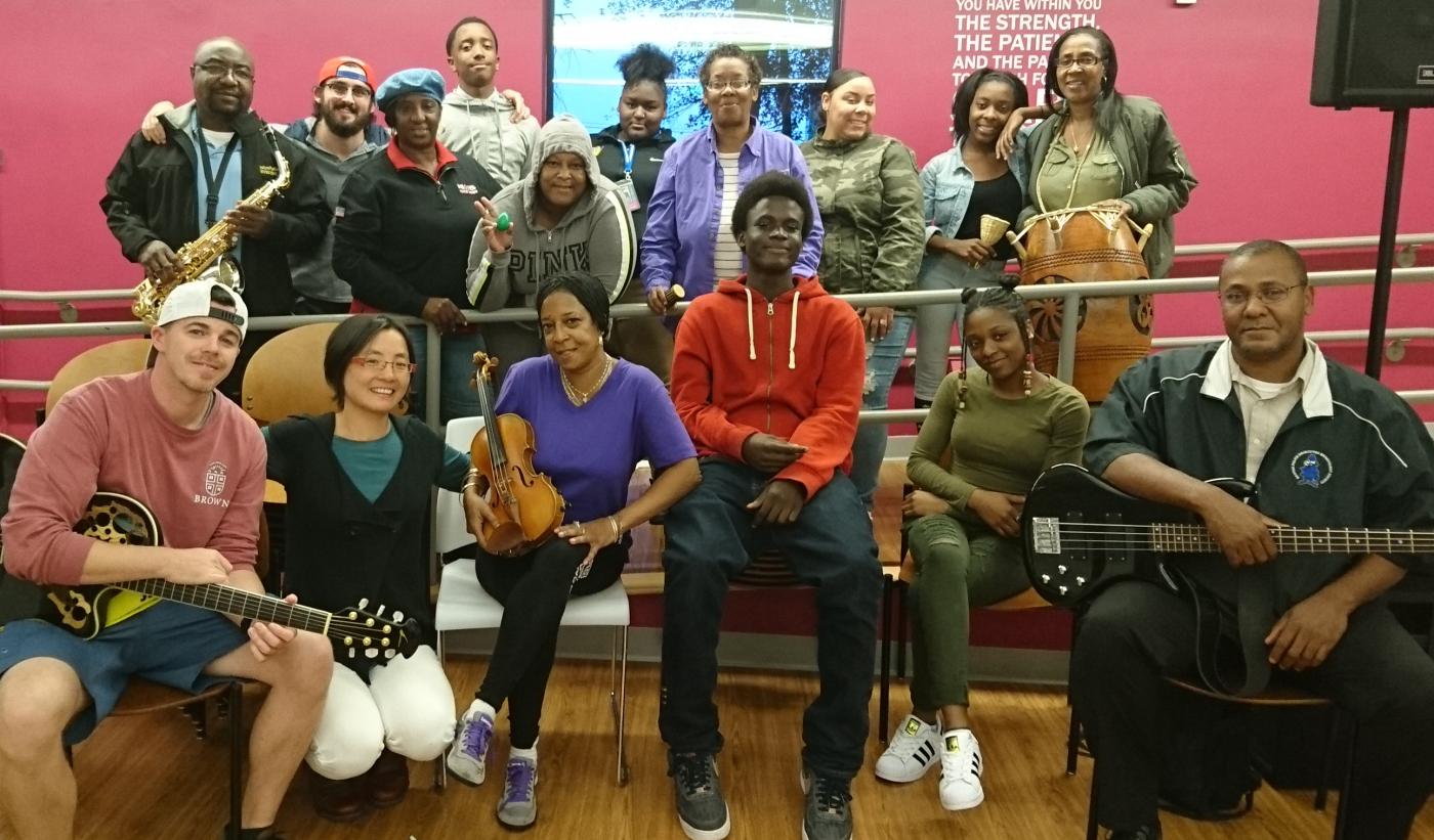 Shaw Pong Liu poses with some students and their instruments.