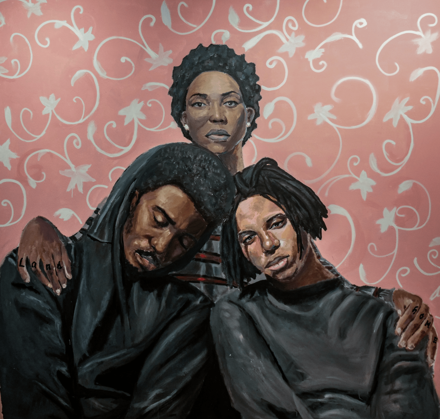 Painting of three black folks leaning against each other, in front of a floral pink and white background.