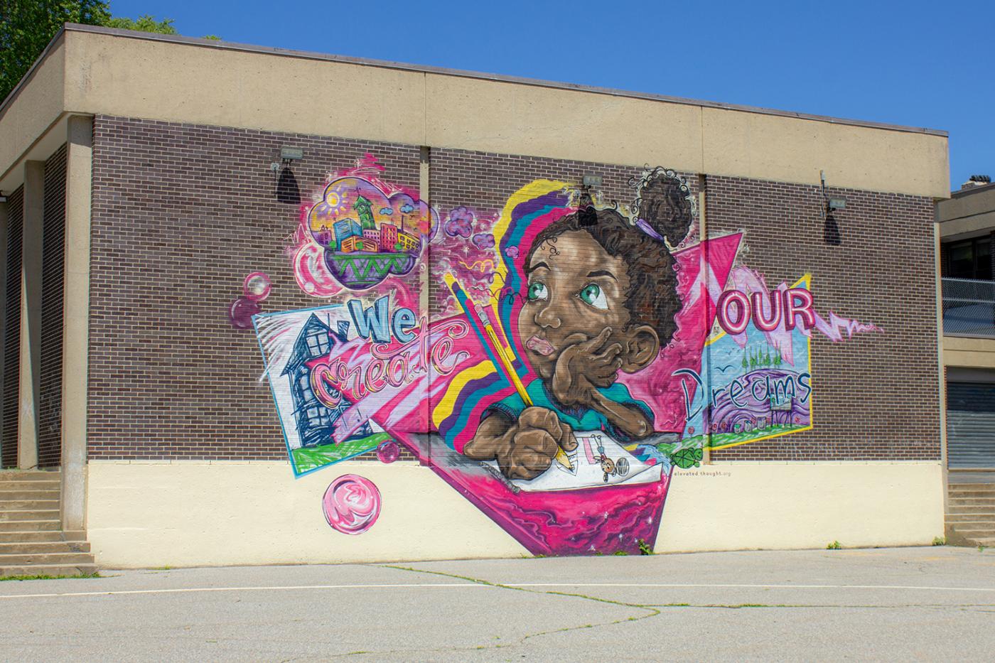Mural on the side of a school of a little Black girl writing in a notebook.