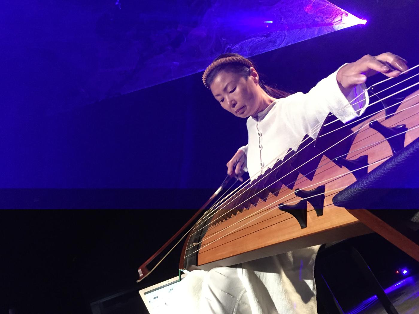 Jin Hi Kim plays the electric komungo, a long stringed instrument.