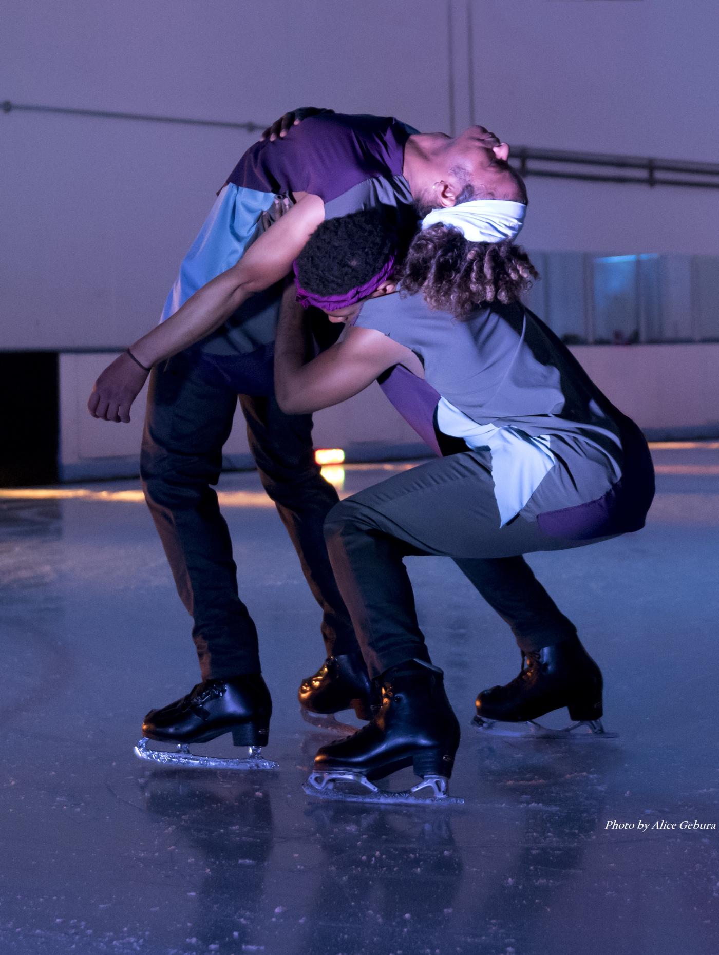A Black ice skater leans over the back of another Black ice skater.