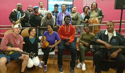 Shaw Pong Liu poses with some students and their instruments.