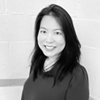 Mina is an Asian woman with long dark hair. This image is in black and white.