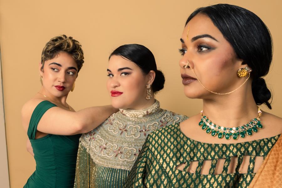 A close up of three people looking forward.