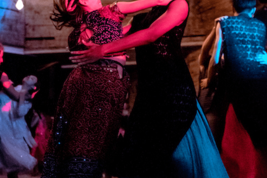 Two performers dance in each others arms.