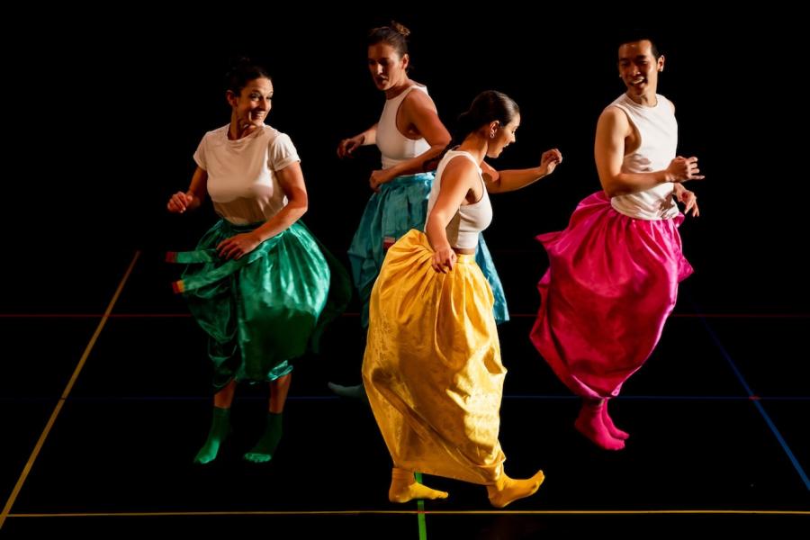 The four dancers perform in a circle.