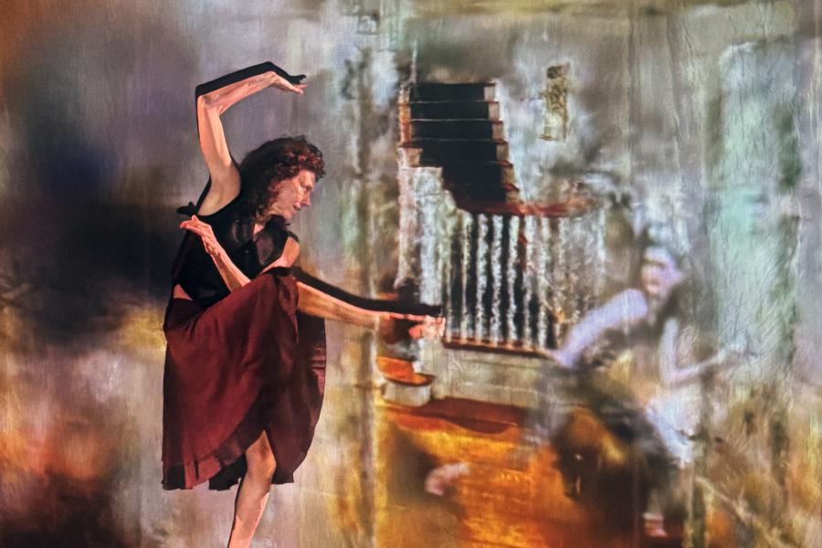 A performer in a red skirt and black top strikes a post.