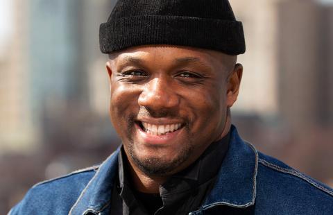 Harold wears a capless black hat and denim jacket. He is a Black person.