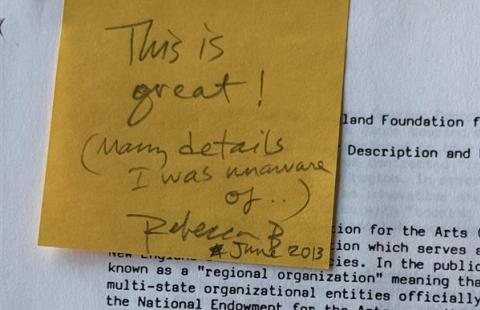 A yellow sticky note on a copy of the Background document. The sticky reads "This is great!"