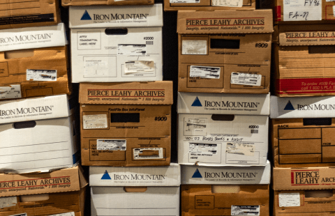 A wall of cardboard boxes piled next to each other.