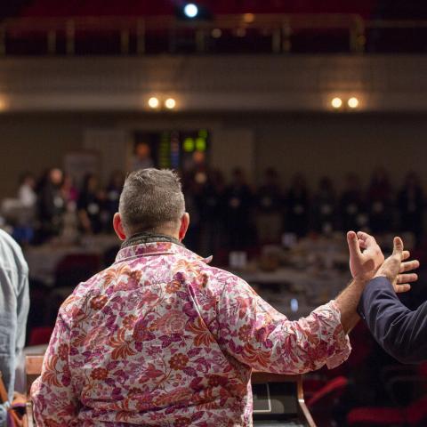 Folks form a circle by touching the back of each other's hands.