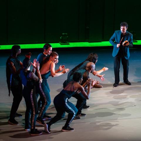 Break dancers and percussionists perform on a stage together