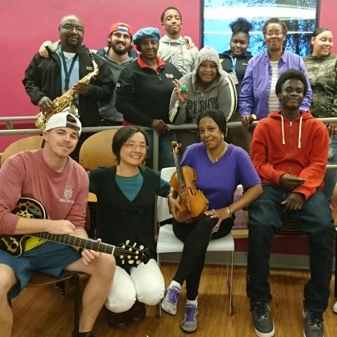 Shaw Pong Liu poses with some students and their instruments.