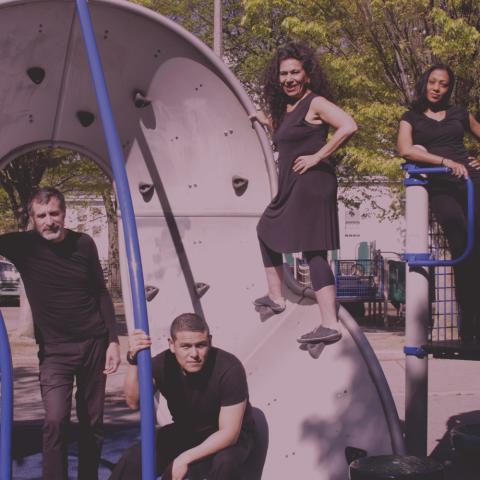 Two women and two men pose in a playground.