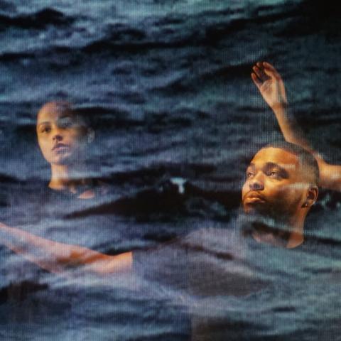 Three people with arms outstretched with arms outstretched as if swimming