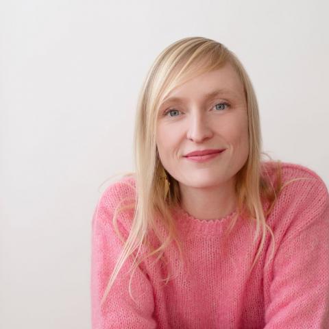 In a pink sweater, Hannah Cole smiles.