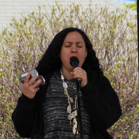 woman singing into a microphone 