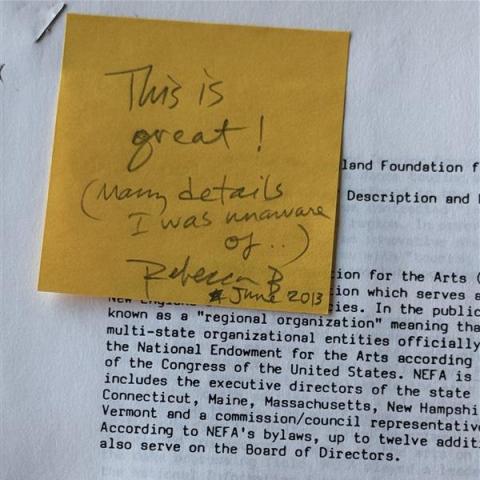 A yellow sticky note on a copy of the Background document. The sticky reads "This is great!"