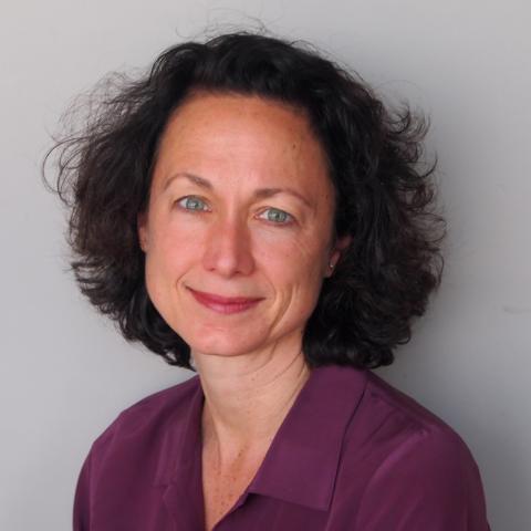 Woman in purple shirt smiles