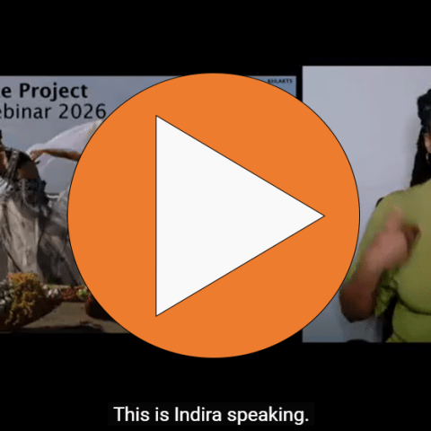 A play button over a slideshow and an ASL interpreter.