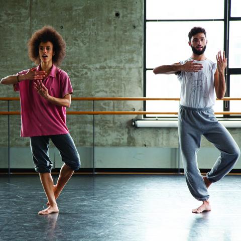 A woman and a man practice in a windowed studio.