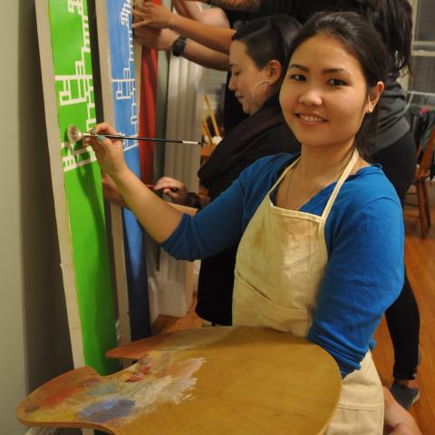 Ngoc-Tran Vu paint with a palette.