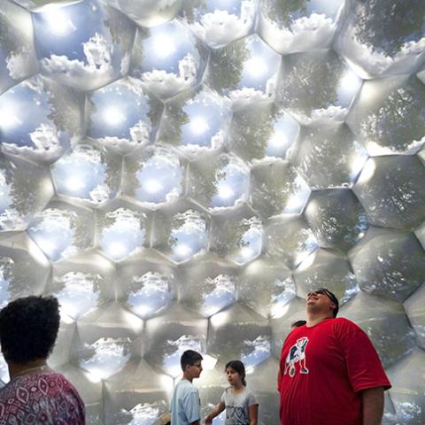 A group of people inside of a giant inflatable structure that appears to be made of bubbles