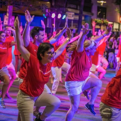 Crowd in red t shirts dances