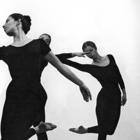 Black and white image of four White or light-skinned dancers in Black leotards.