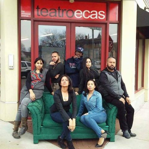 eight Latinx people pose in front of the venue for Teatro ECAS, the longest running Spanish speaking theater in New England.