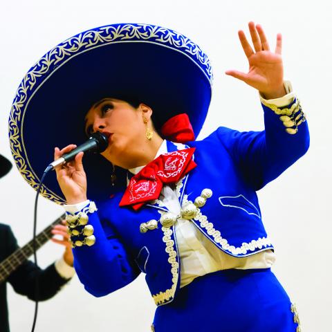 Mariachi singer Veronica Robles, in a sombrero, sings.
