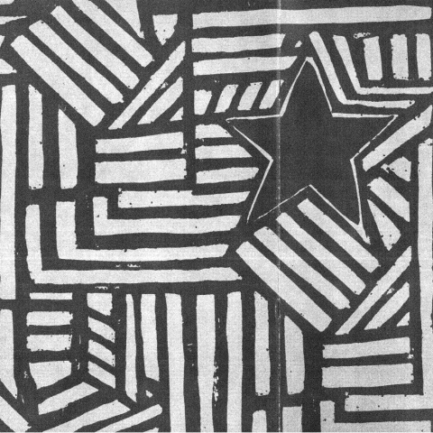 A wood carved print of a start and intersecting lines.
